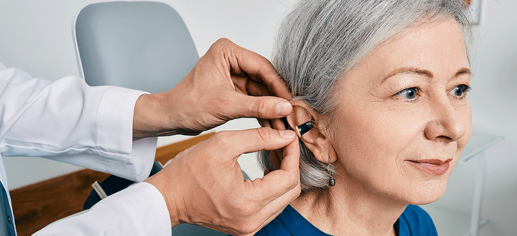 woman getting fitted with hearing aid